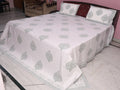 Close-up of slate grey medallion hand block printed pattern on cotton percale fabric