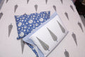 Close-up detail of indigo hand block printed cotton fabric showing artisan botanical pattern