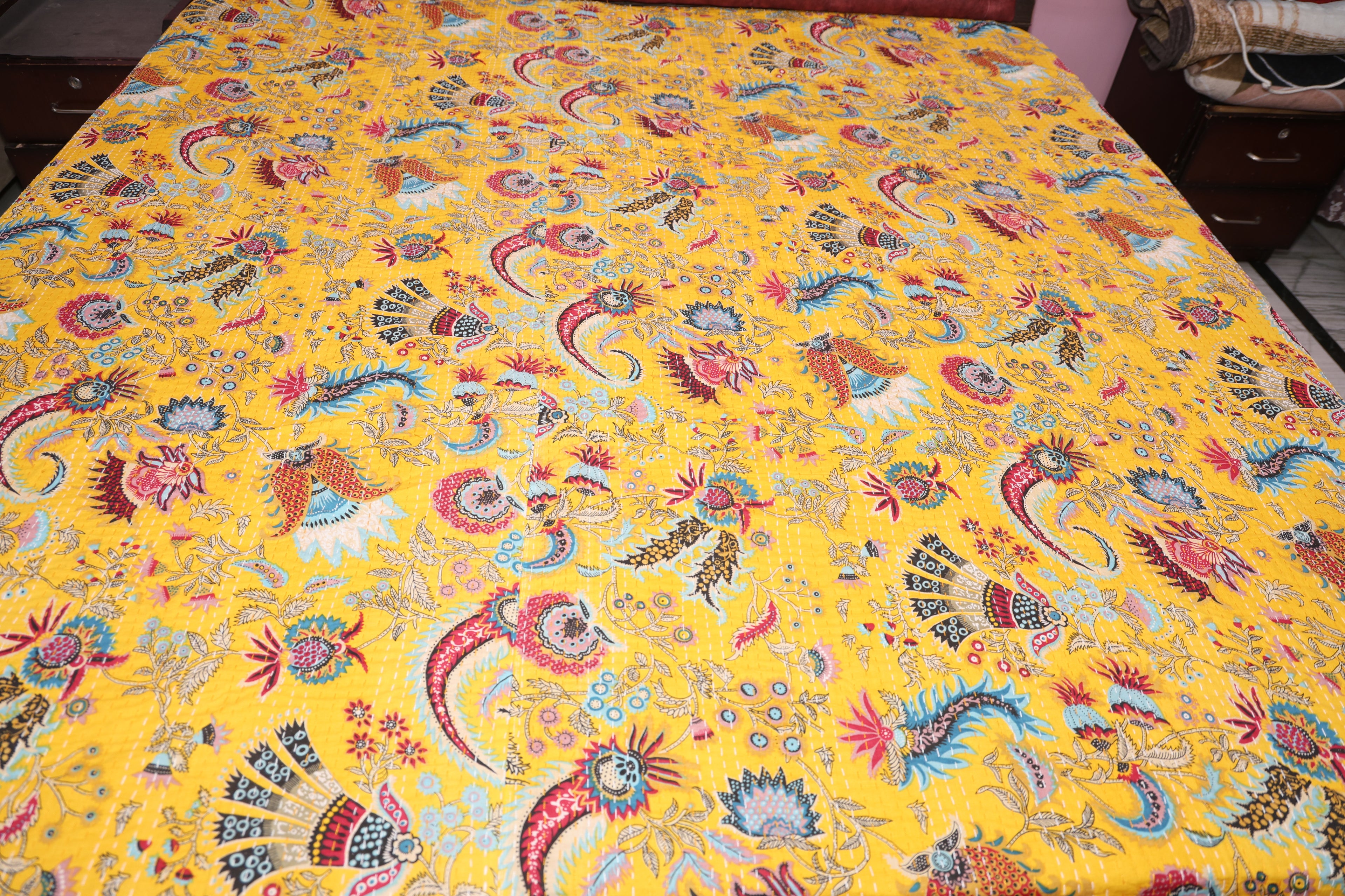 Detail of saffron paisley kantha throw showing both fabric layers and stitch work