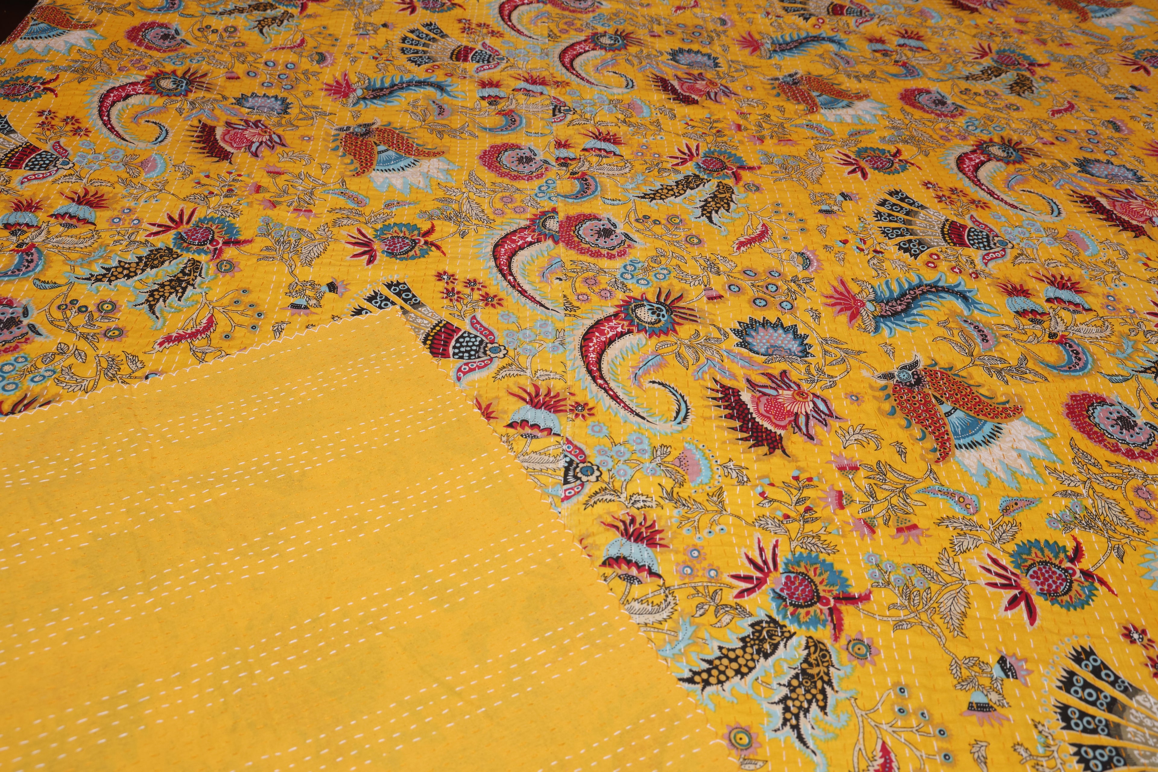 Saffron paisley kantha throw styled on bed as lightweight coverlet