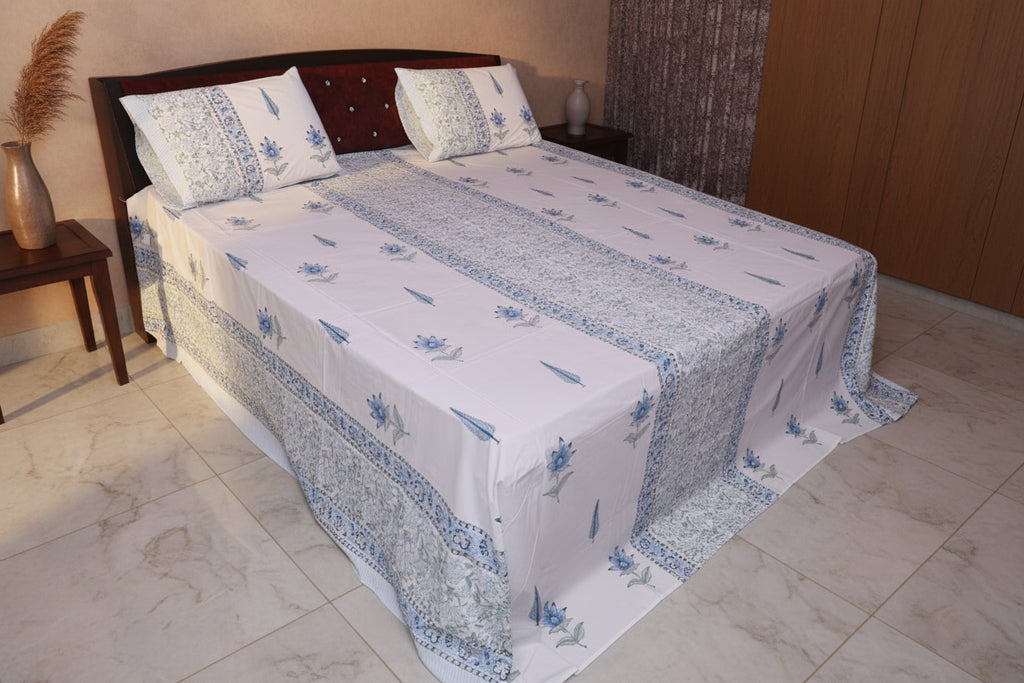 Azure Palace cotton sheet set with matching pillow covers folded on wooden surface