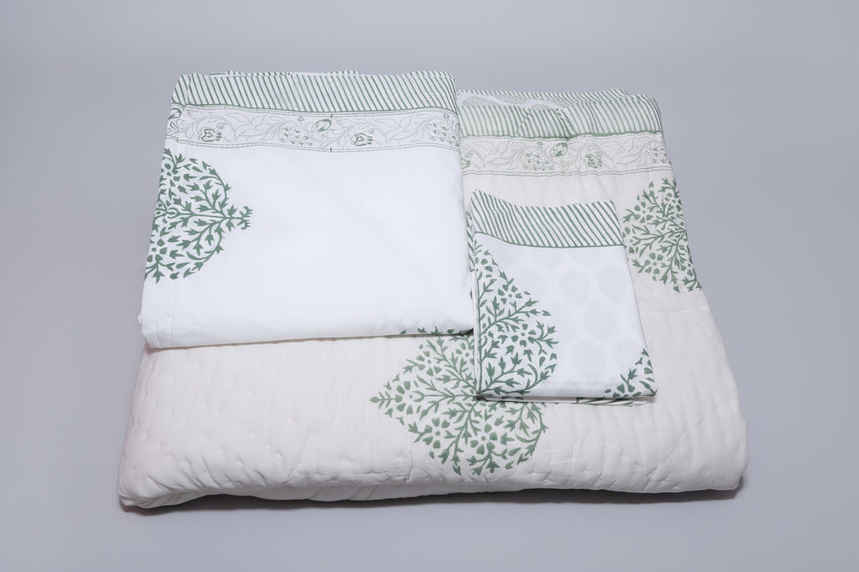 Grey floral bedding set pillow covers and bedsheet detail on styled bed