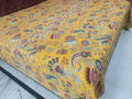 Close-up of saffron paisley and peacock hand-stitched kantha pattern