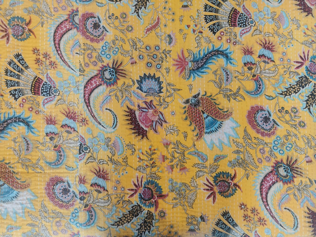 Saffron paisley kantha throw styled on bed as lightweight coverlet