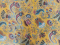 Saffron paisley kantha throw draped over sofa showing peacock motif design