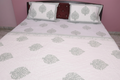 Grey floral hand-block printed cotton bedding set contents — quilt, bedsheet, and pillow covers