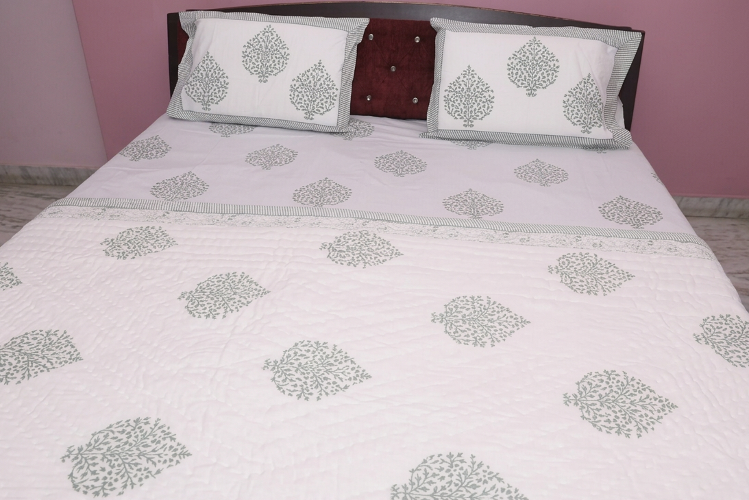 Grey floral hand-block printed cotton bedding set contents — quilt, bedsheet, and pillow covers