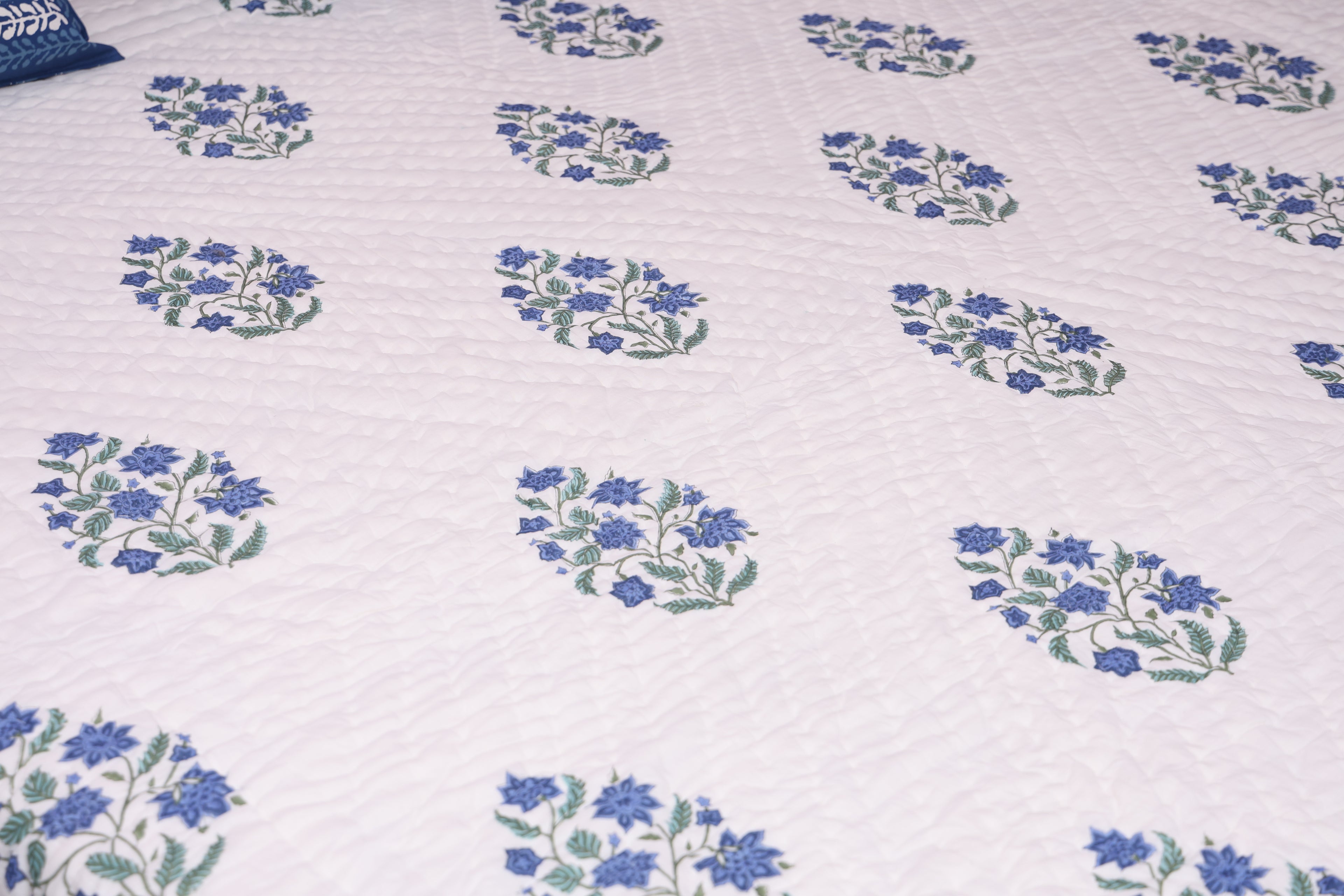White fabric with blue floral butta