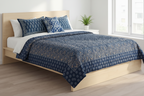 Gilded indigo block print quilt with gold dust accents styled on bed — lifestyle shot