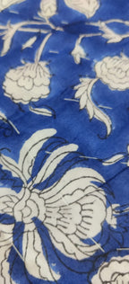 Close-up of blue fabric with white floral pattern