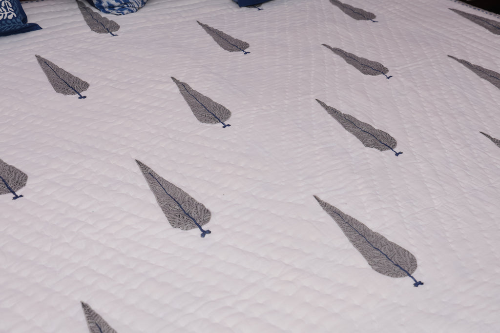 Patterned fabric with feather designs on a white background
